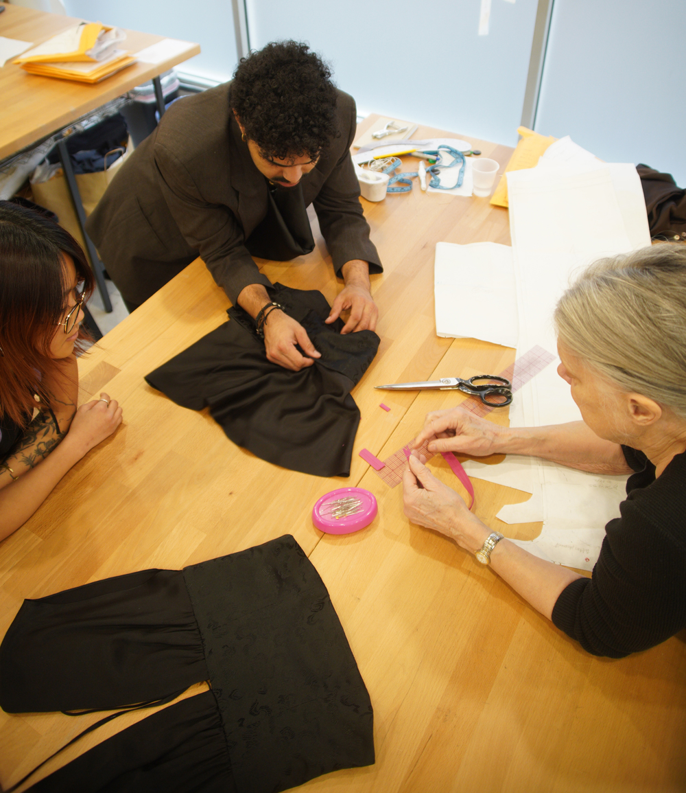 Elizabeth, Esteban, and Thea discussing the construction of a garment.