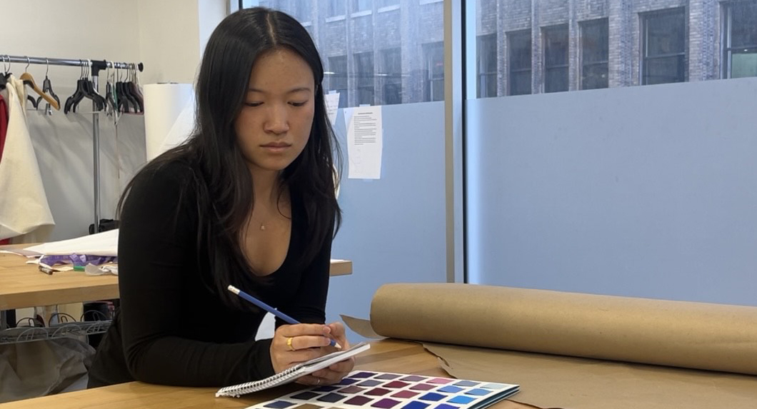 Image of Maya reviewing a color pallette in preparing a design sketch.
